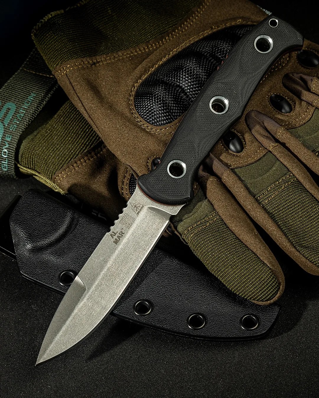 Al Mar x Tops SERE Operator knife laying on tactical gloves and sheath