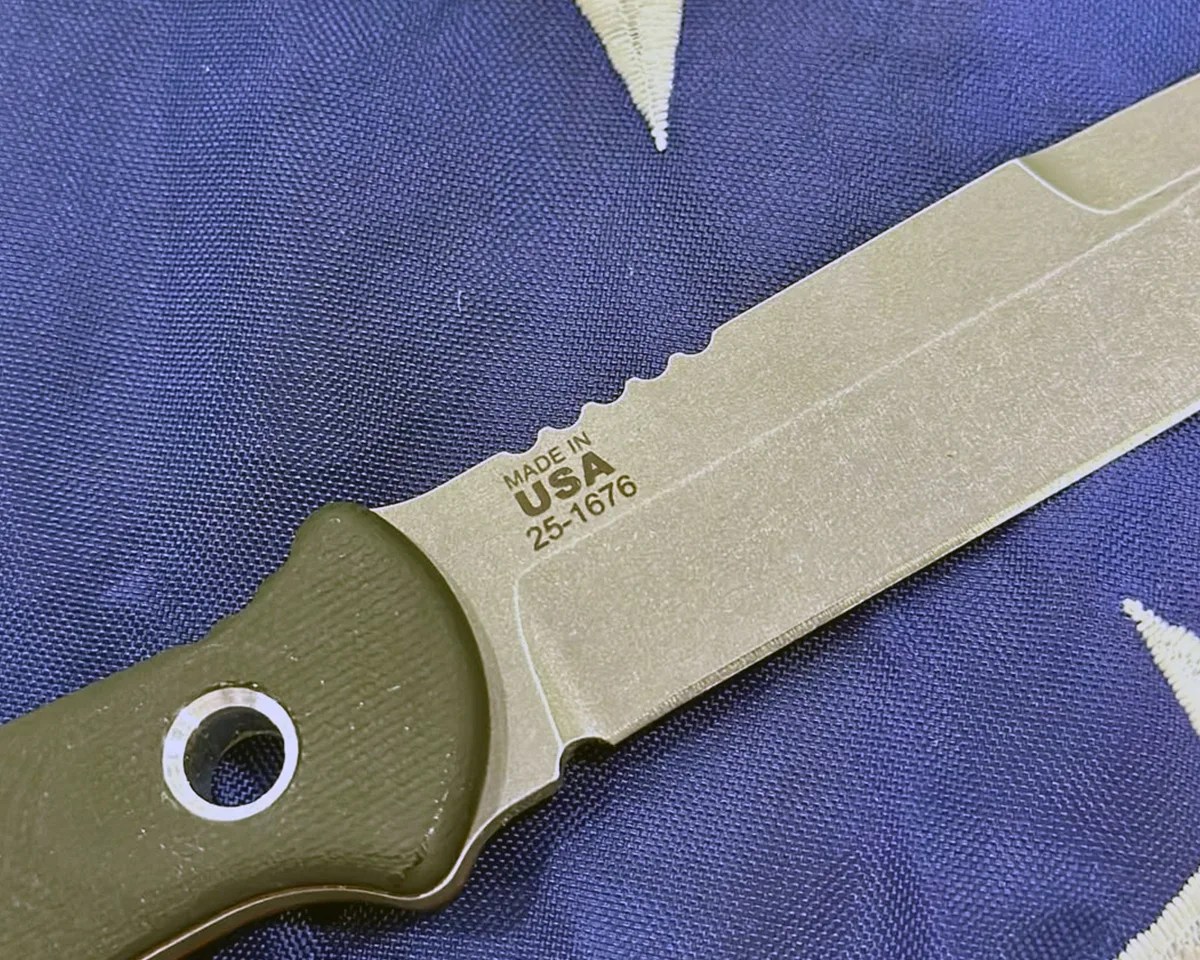 closeup of Al Mar x Tops SERE Operator knife laying on American flag
