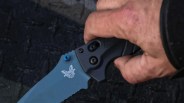 Closeup of Benchmade Adira serrated knife in man's hand