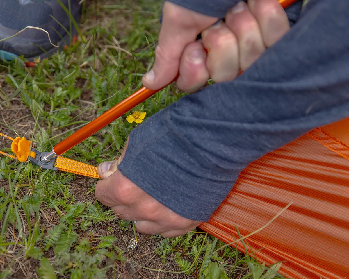 Closeup of man setting up Big Agnes tent
