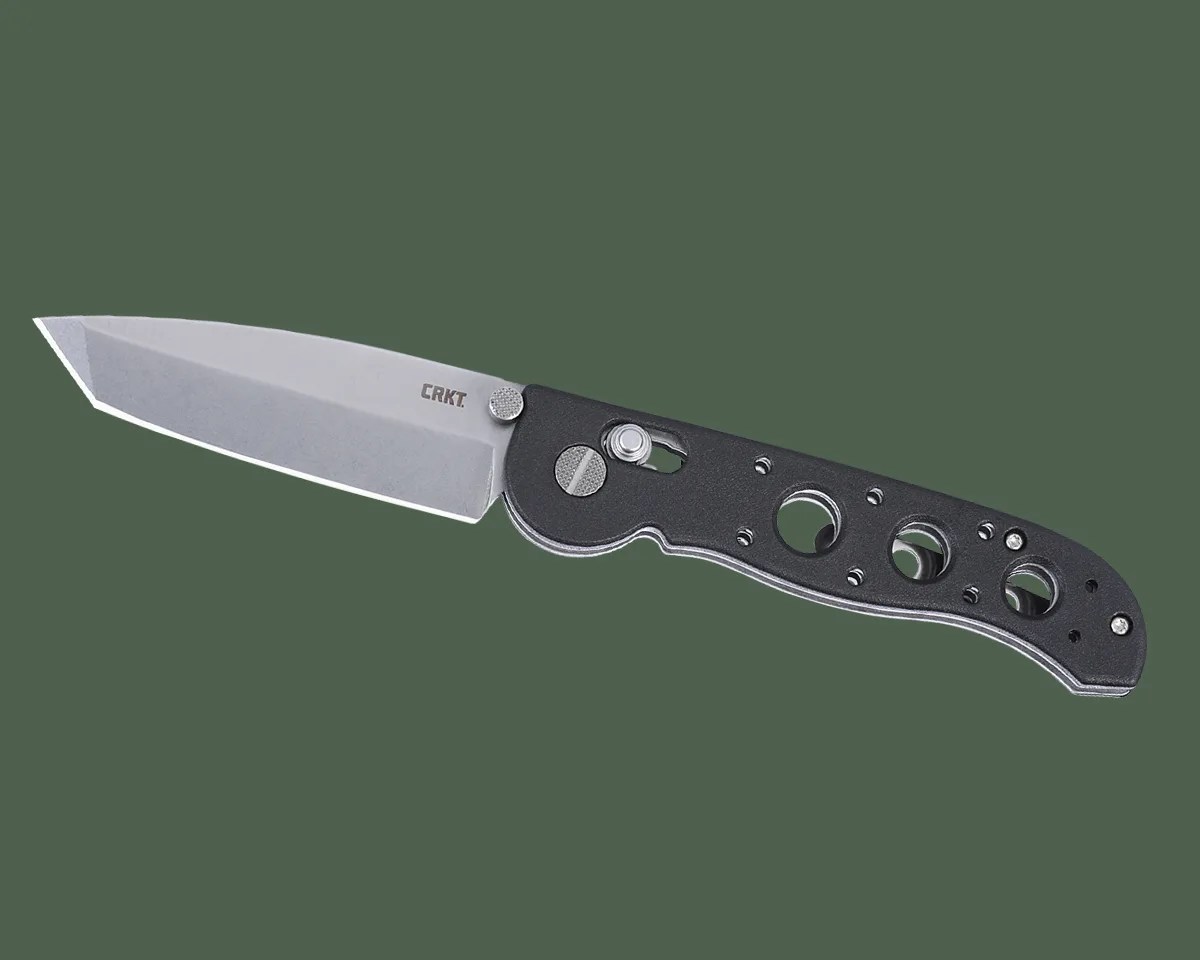 CRKT M16 Crossbar knife on green background
