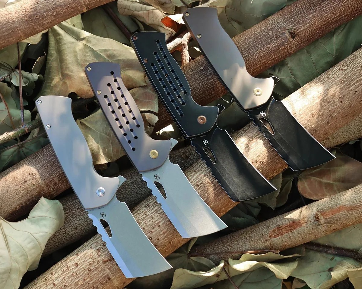 Group shot of Kansept Leviathan knives on tree branches over leafy underbrush
