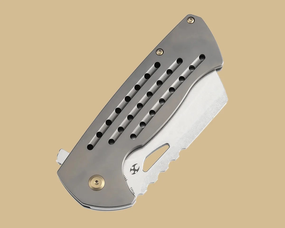 Closed Kansept Leviathan knife on tan background