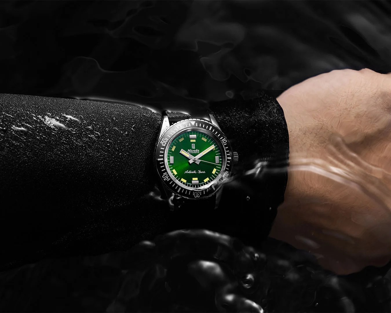 Nivada First Dive Watch Antarctic Diver in Green worn on wrist partially submerged in water