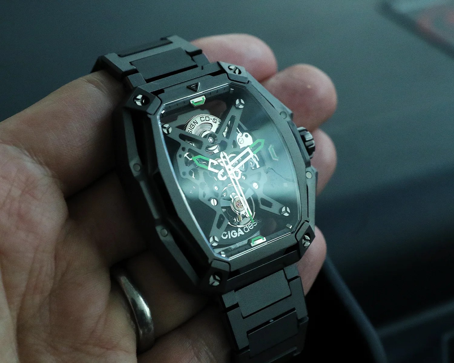 a ciga design skeleton watch held in hand