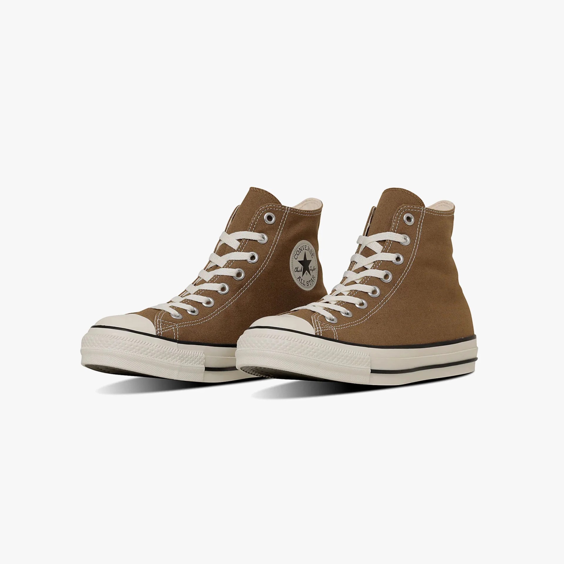 the side of profile of a pair brown converse all star sneakers