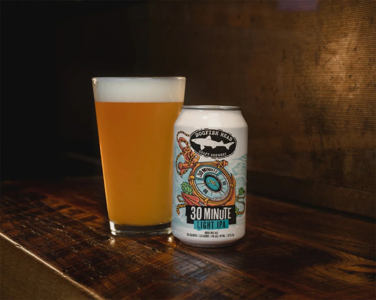 a can of beer next to a glass