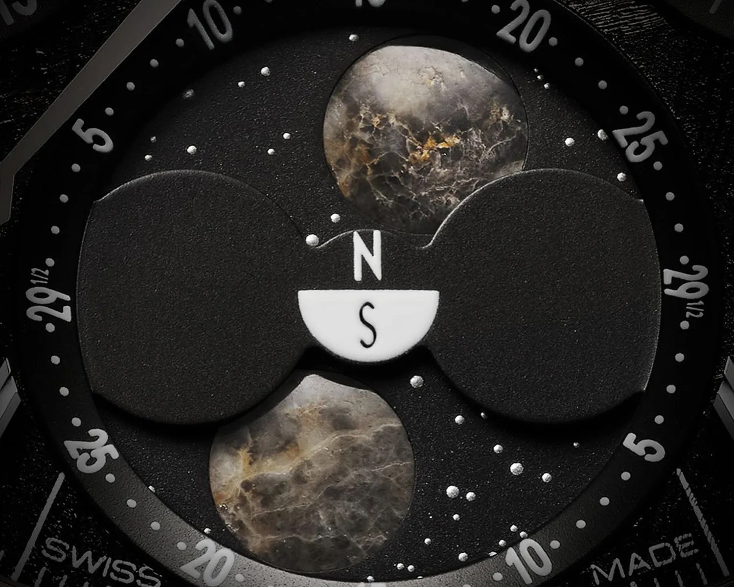 a closeup of an omega speedmaster moonphase watch complication