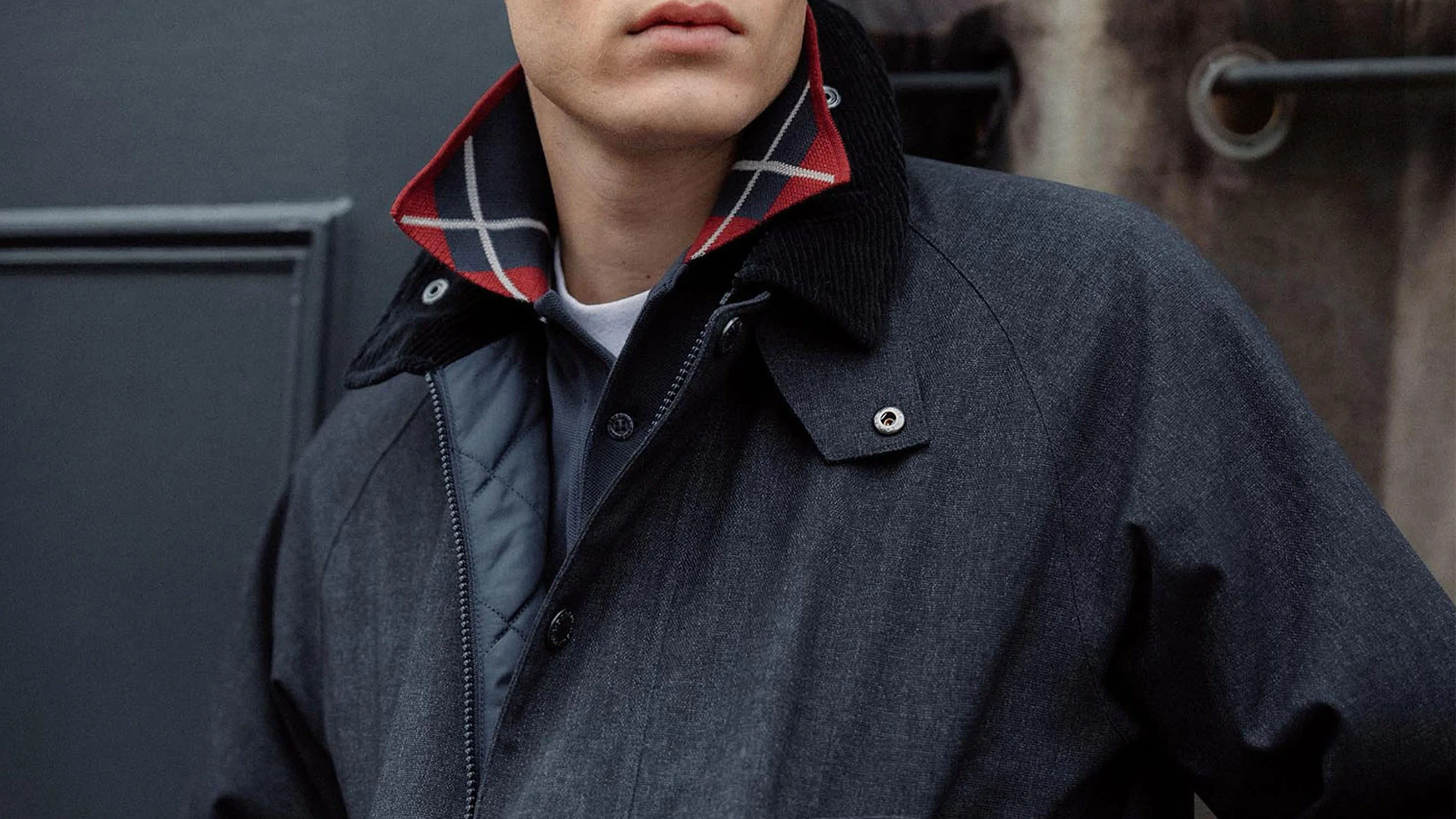 A male model wearing a Barbour Bedale jacket in navy blue. Only the chest and neck area are shown.