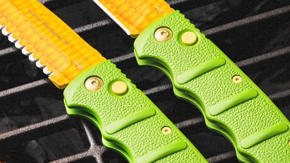 Closeup of Böker Kalashnicob auto knives on grill