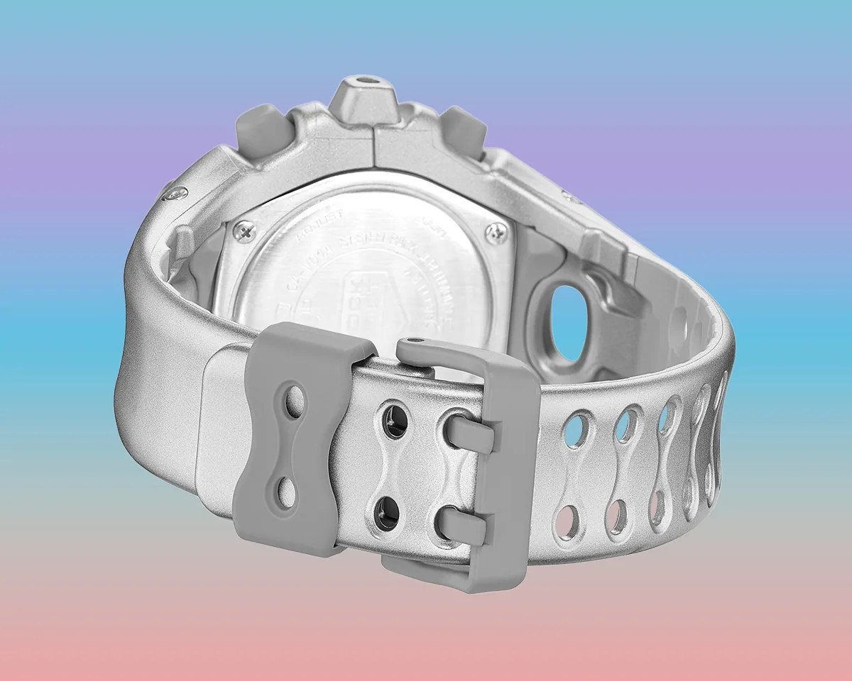 Backside of Casio G-Shock GA-V01 watch on pastel rainbow background