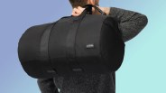 Rimowa Foldable Gym Bag in man's hand on blue background