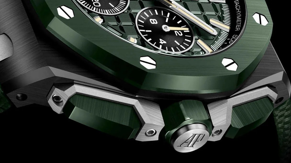 the green bezel and crown of a watch