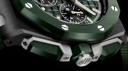 the green bezel and crown of a watch