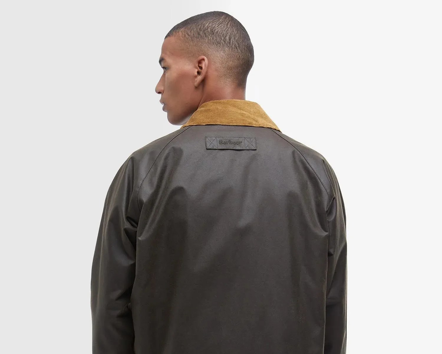 the back of a man in a green barbour jacket