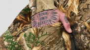 close up of a hand in a Flint and Tinder Real Tree camo hoodie pouch
