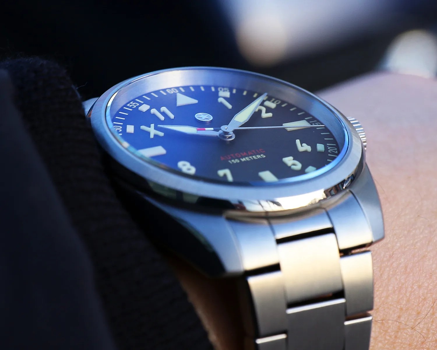 a closeup of a jack mason pilots watch on a mans wrist