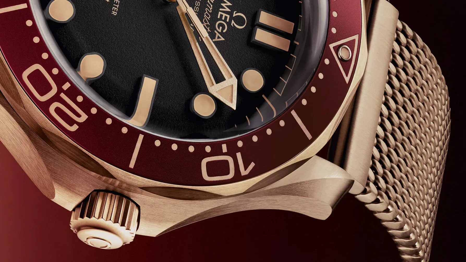 the gold case and bracelet of an omega seamaster dive watch