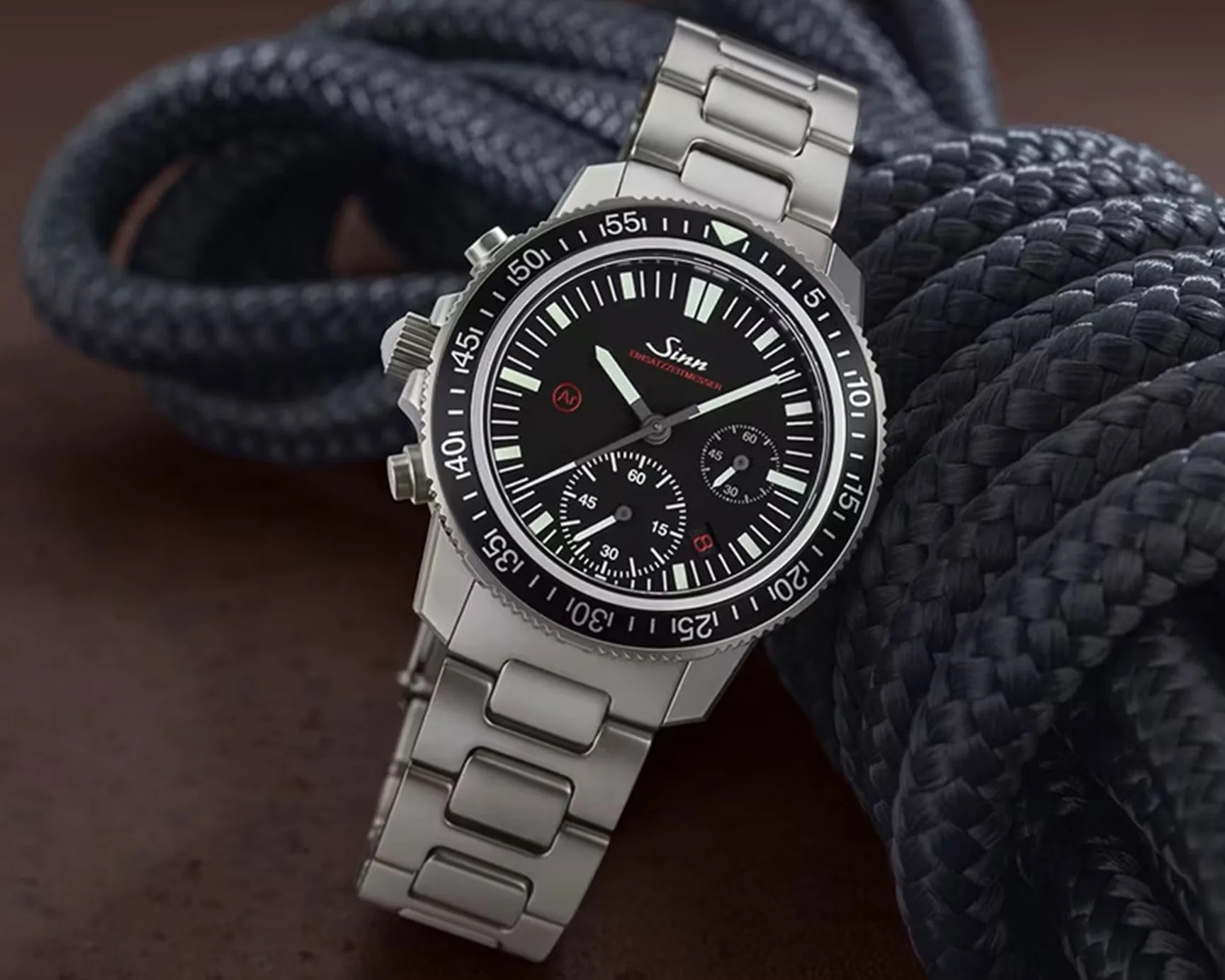 a steel dive watch with a black dial