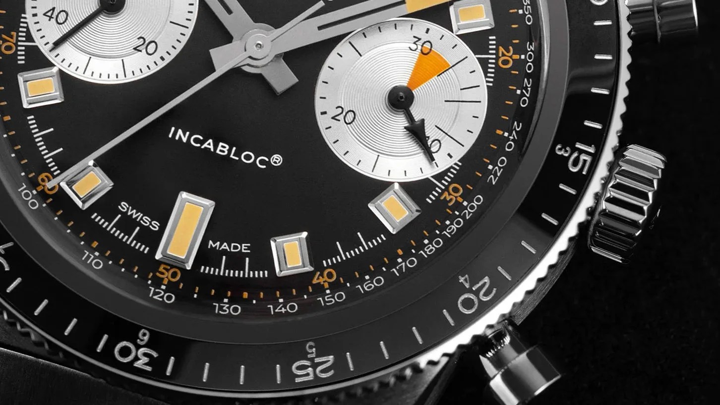 close view of the dial and bezel on a chronograph watch