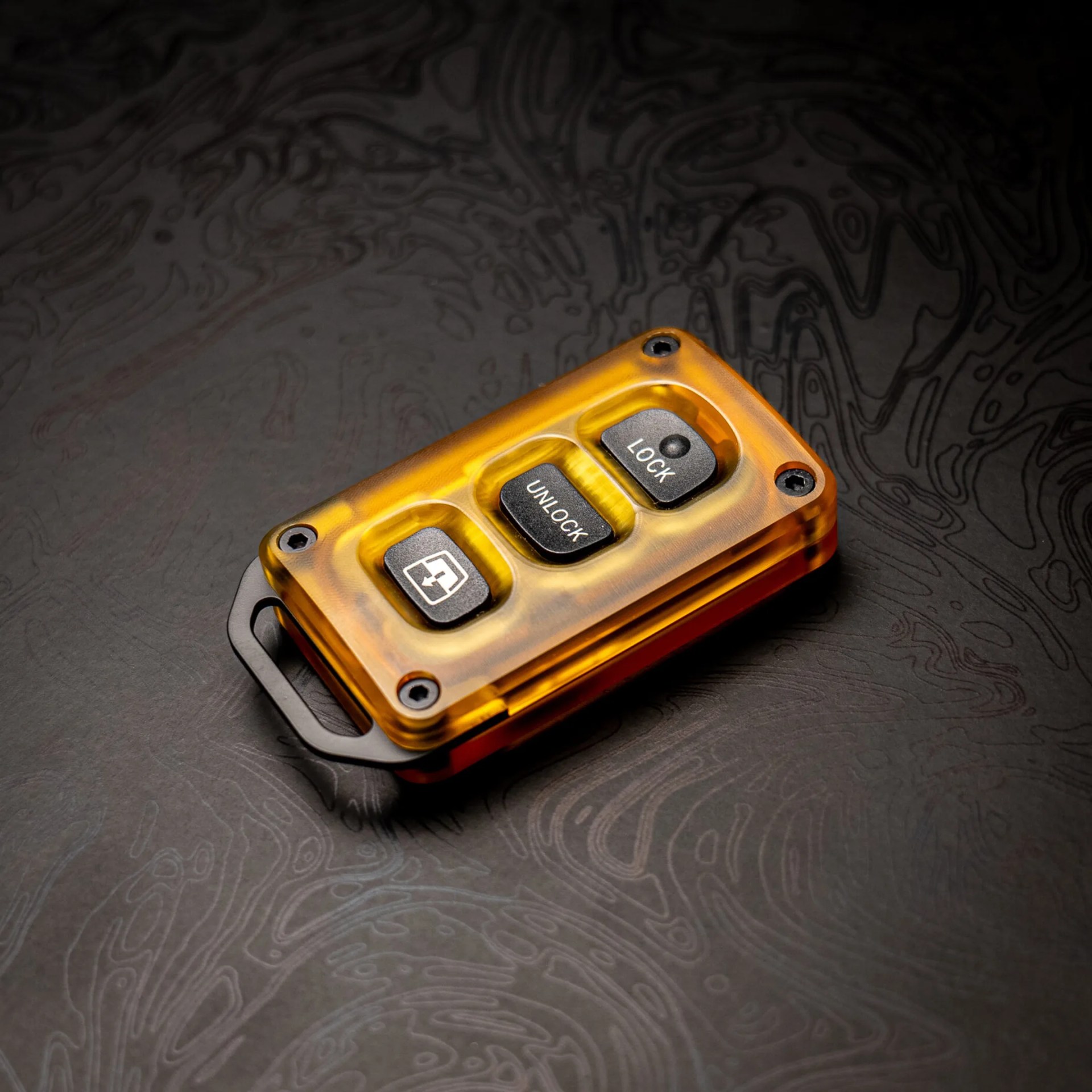 Mace MFG Titanium x Ultem Key Fob on black topo background