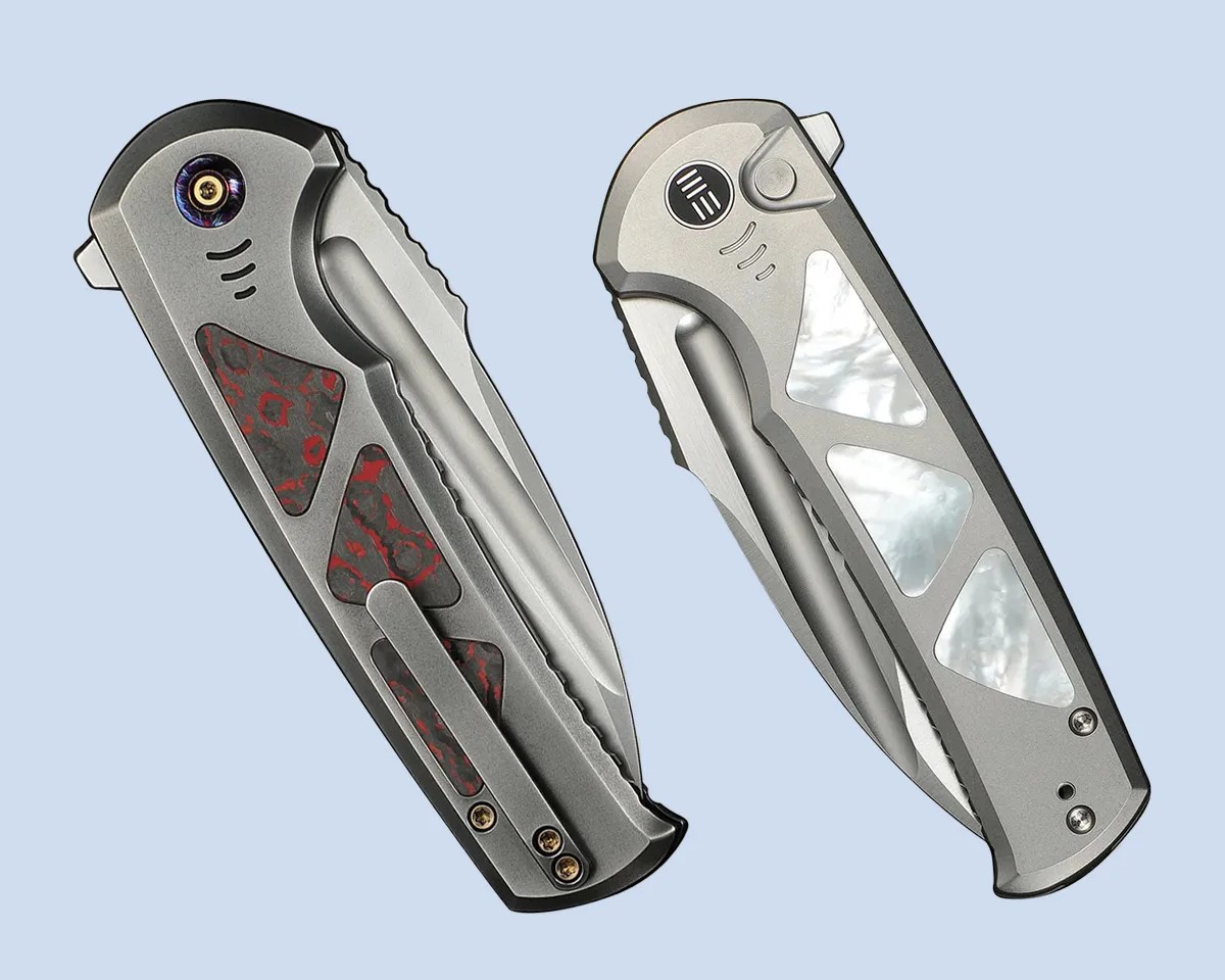 two We Knife Sylox knives closed on blue background