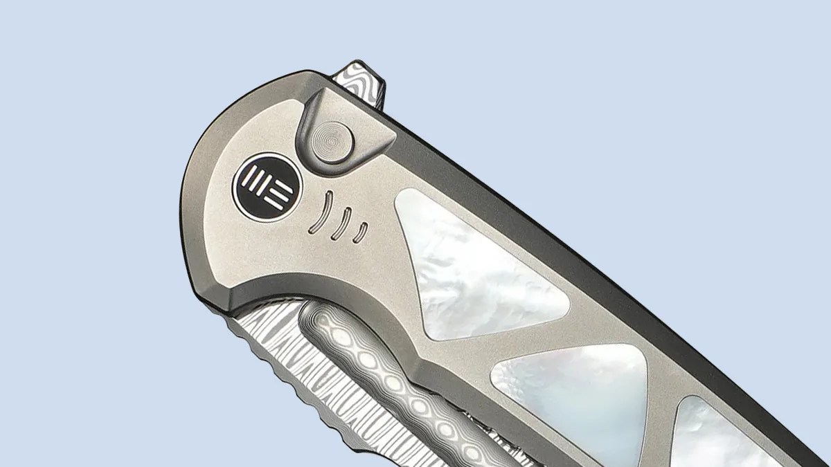 Closeup of We Knife Sylox knife on blue background