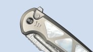 Closeup of We Knife Sylox knife on blue background