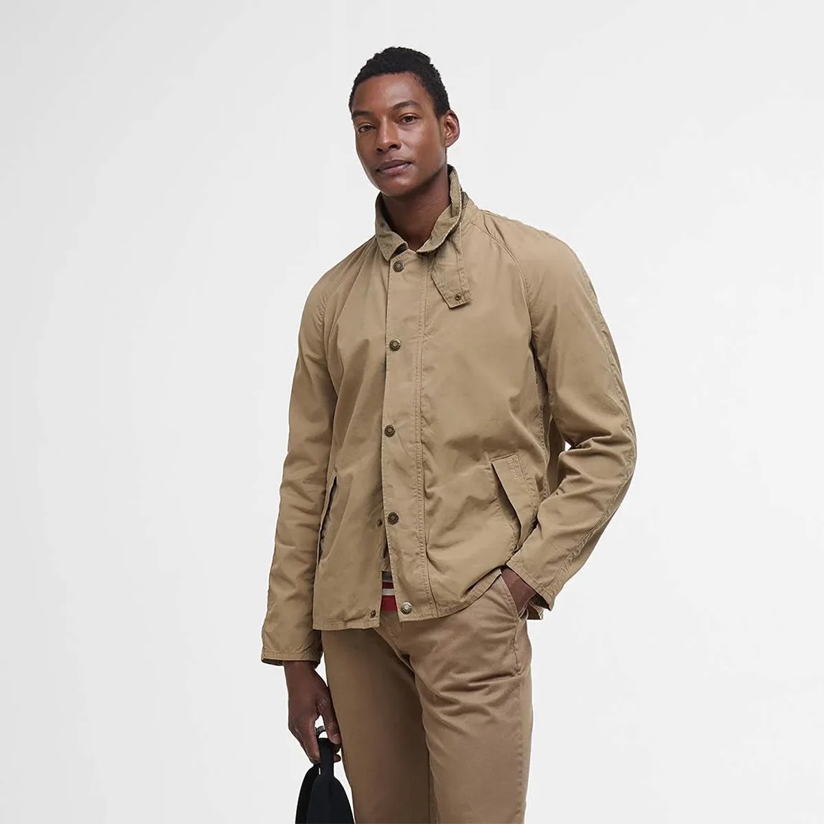man wearing barbour tracker casual jacket in beige