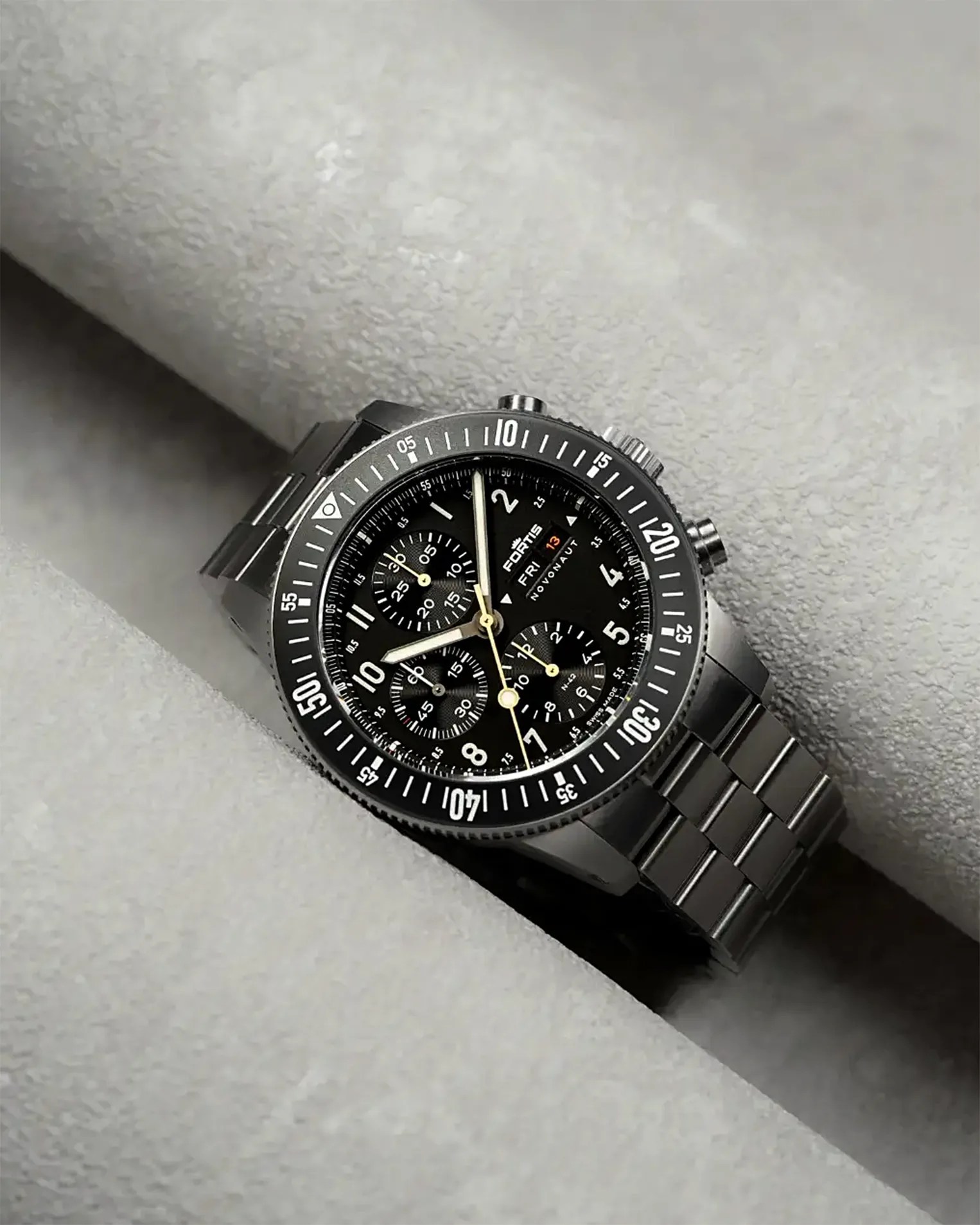 a steel chronograph watch with a black dial