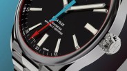 a steel watch with a black dial