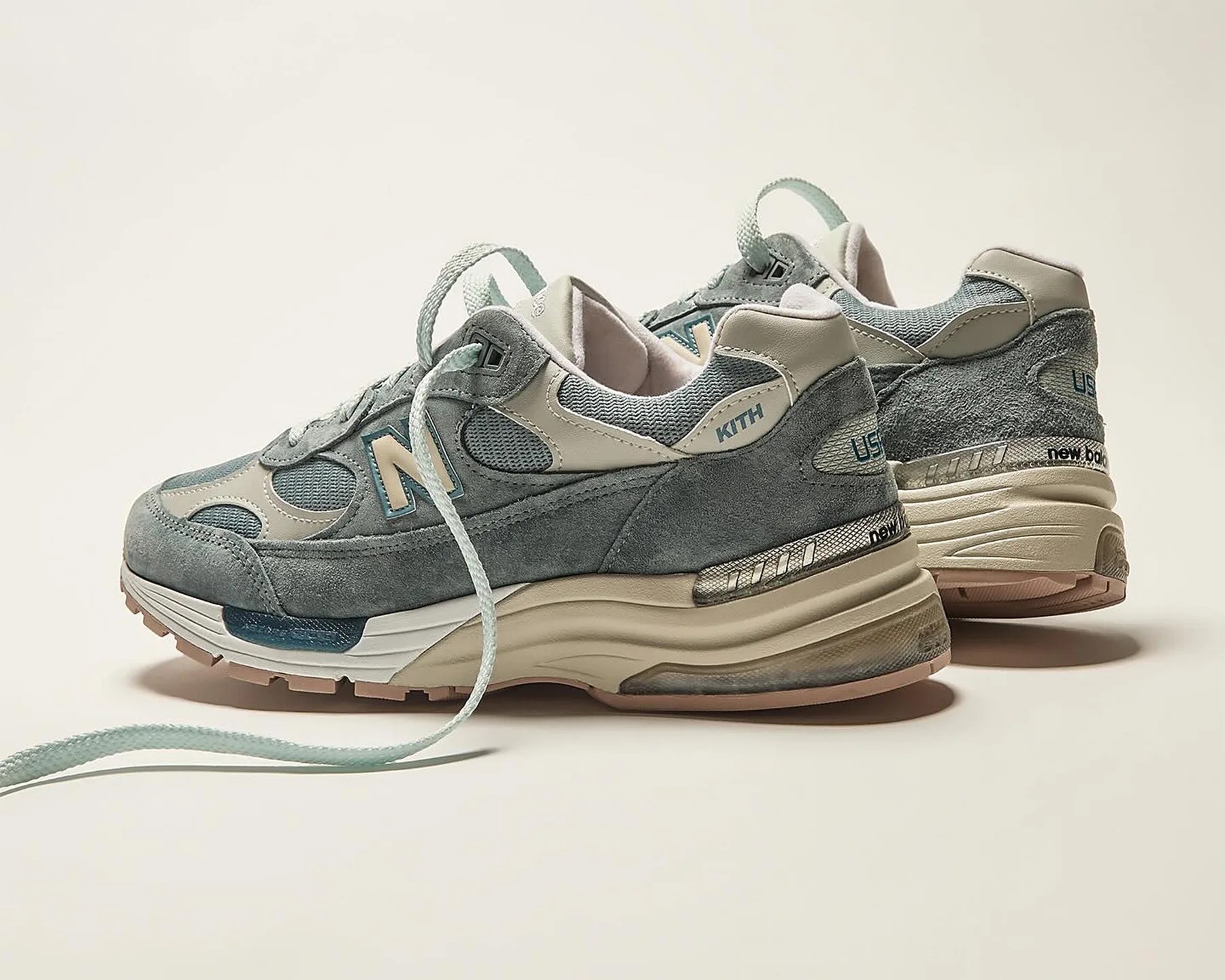 the back of a pair of light blue new balance sneakers