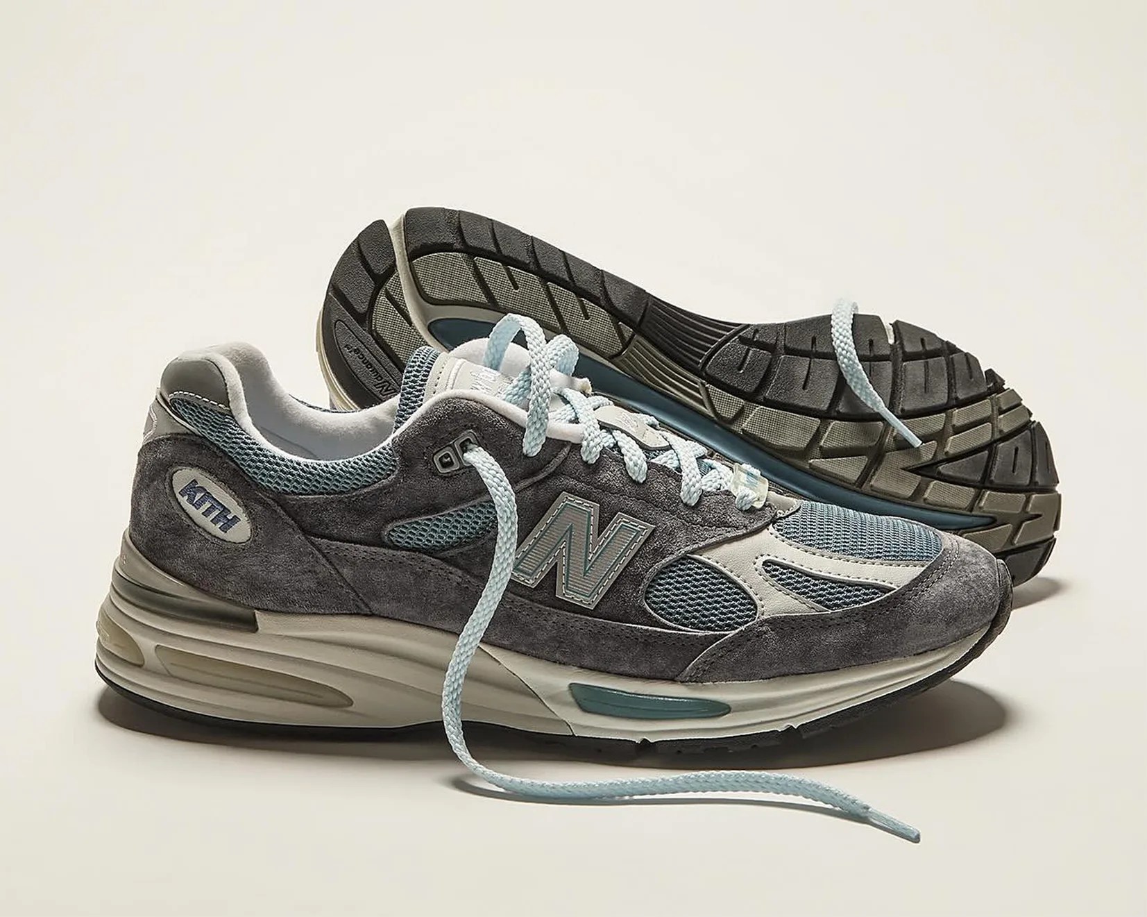 a pair of gray and blue New Balance running shoes