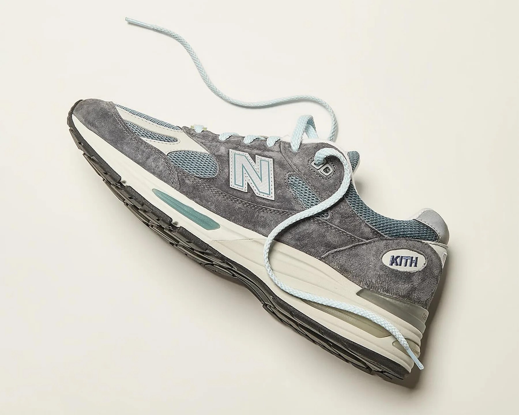a gray and blue New Balance running shoe
