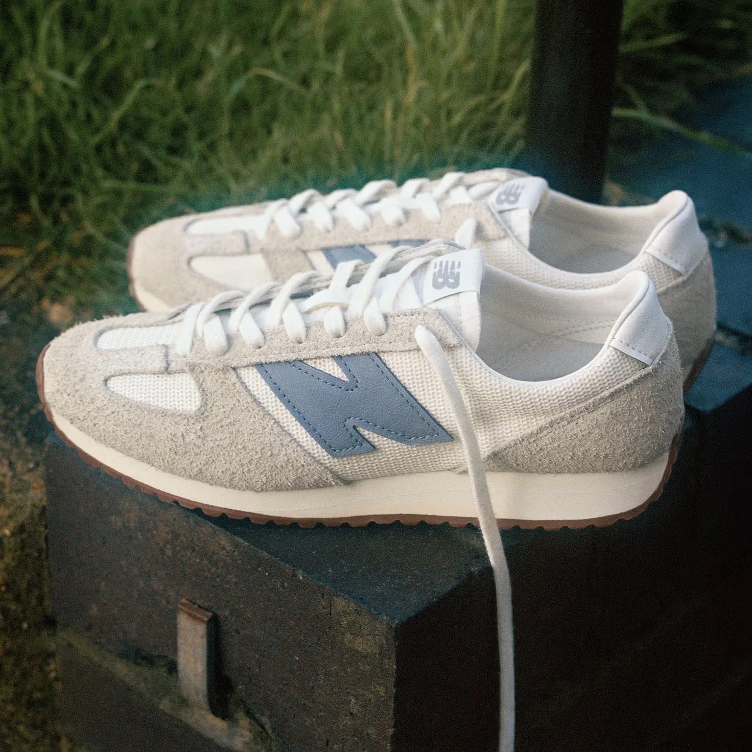 a pair of white New Balance sneakers