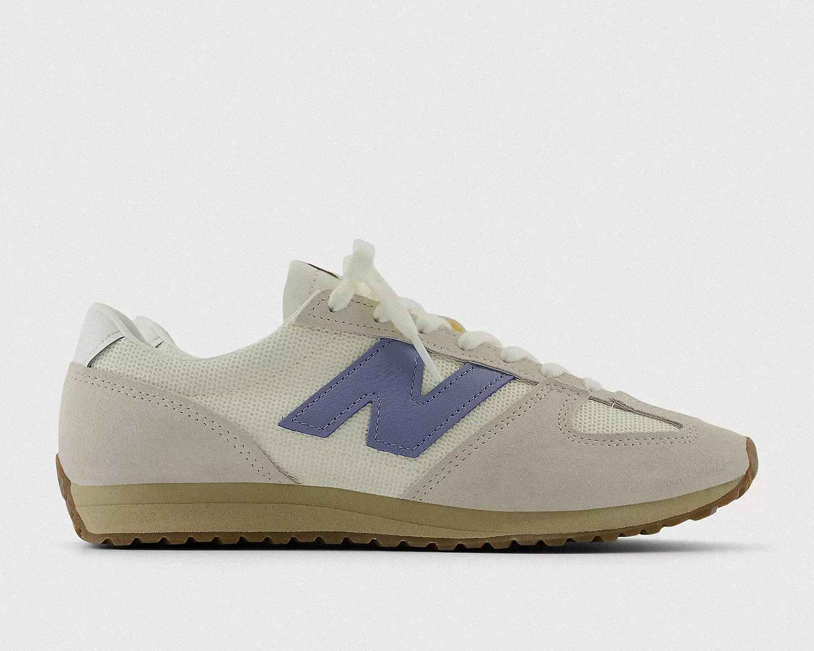 a pair of white New Balance running shoes from the side