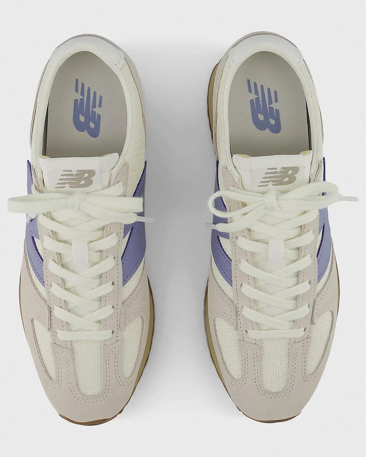 a pair of white New Balance running shoes