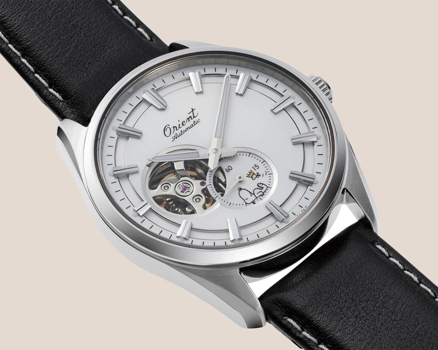 an white watch with a seethrough section on the dial