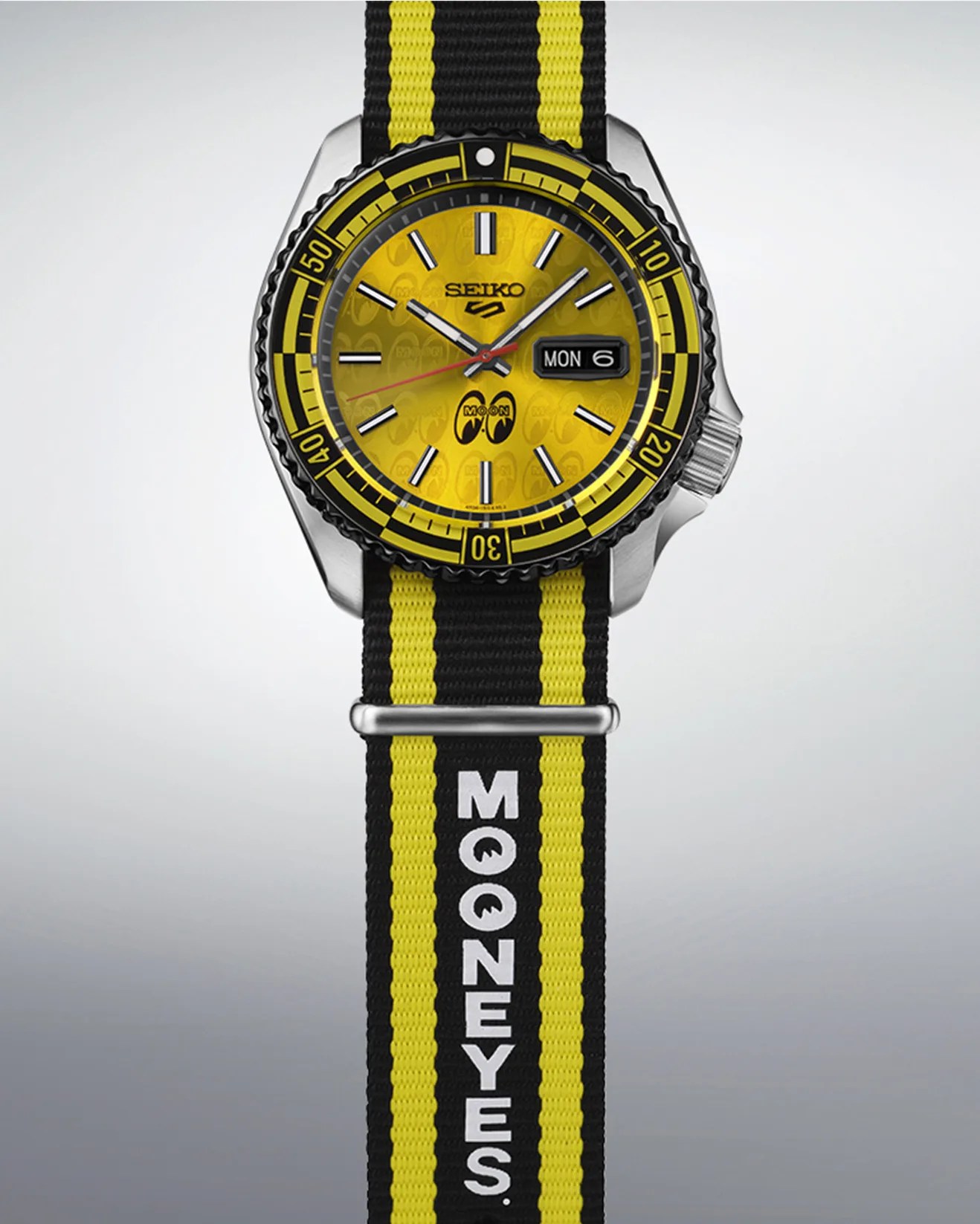 a yellow dial watch with a black and yellow nylon band