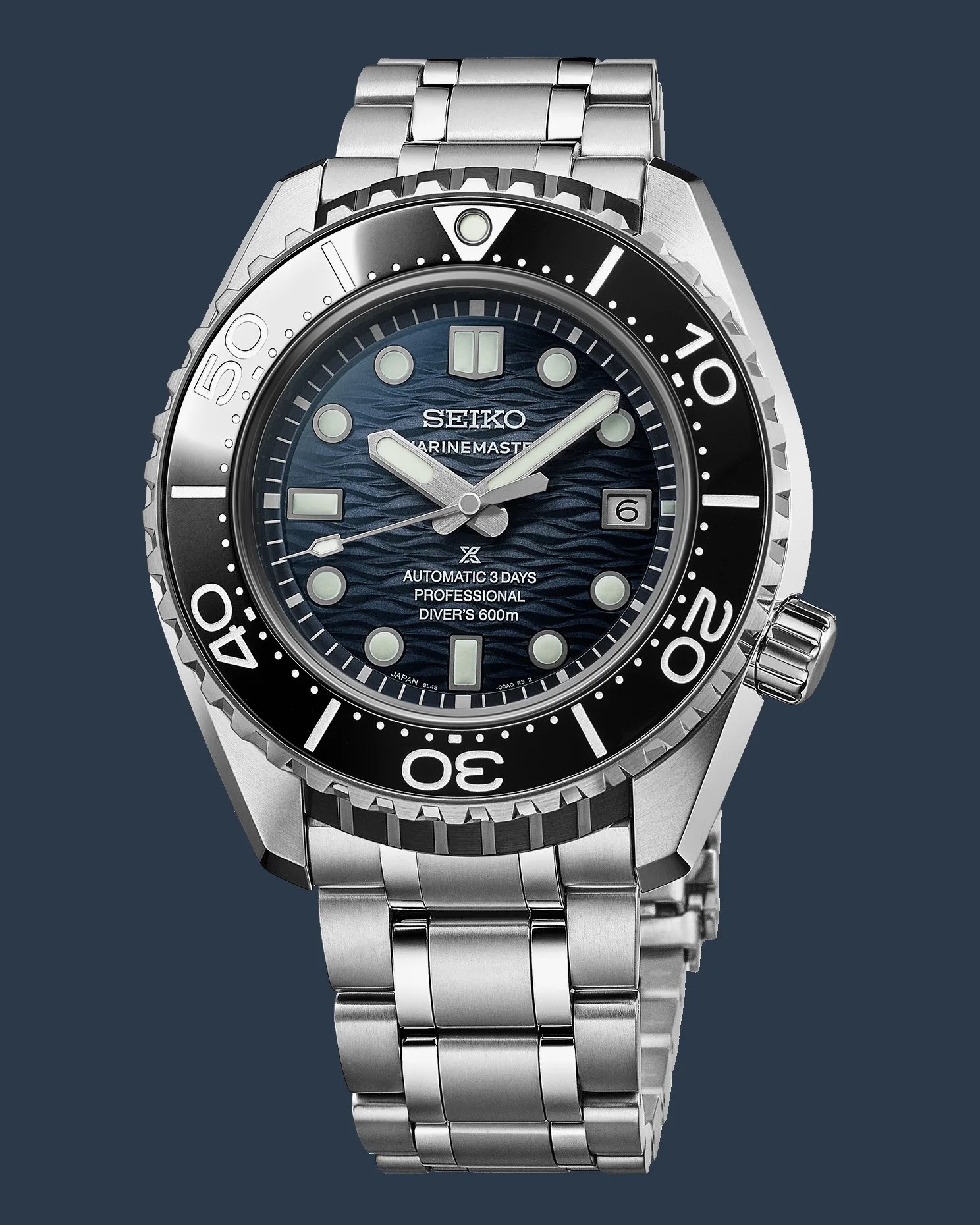 a steel Seiko dive watch with a blue dial and black bezel