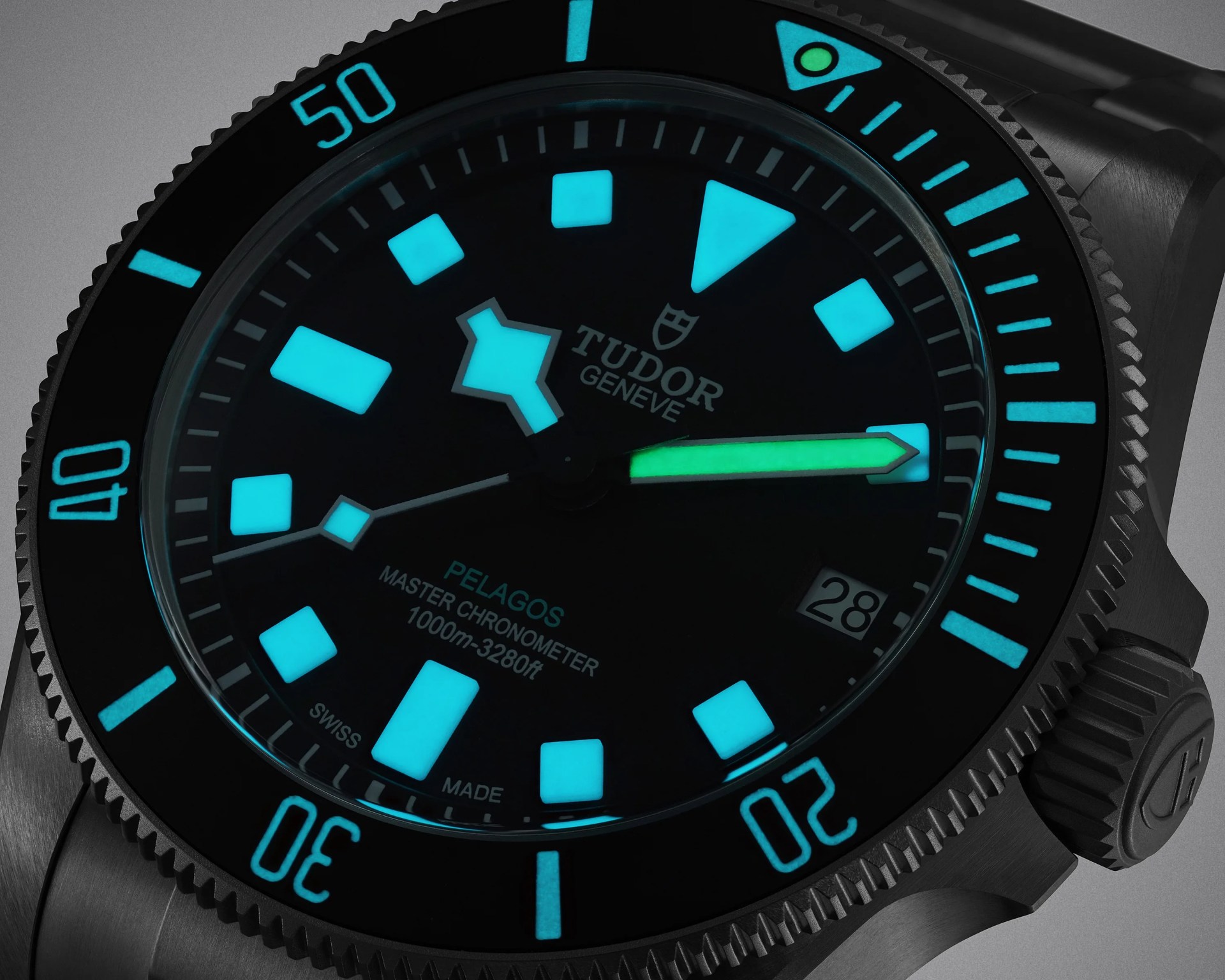 A close up of the Tudor Pelagos Ultra with the blue and green lume brightly showing