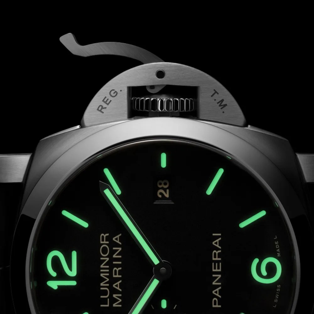 a closeup of a panerai luminescent watch dial and crown