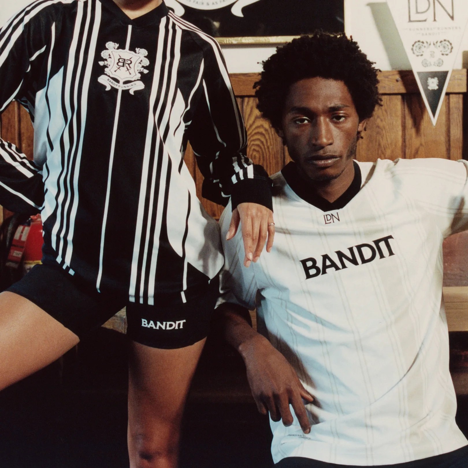 a man in a soccer jersey next to a woman in a soccer jersey