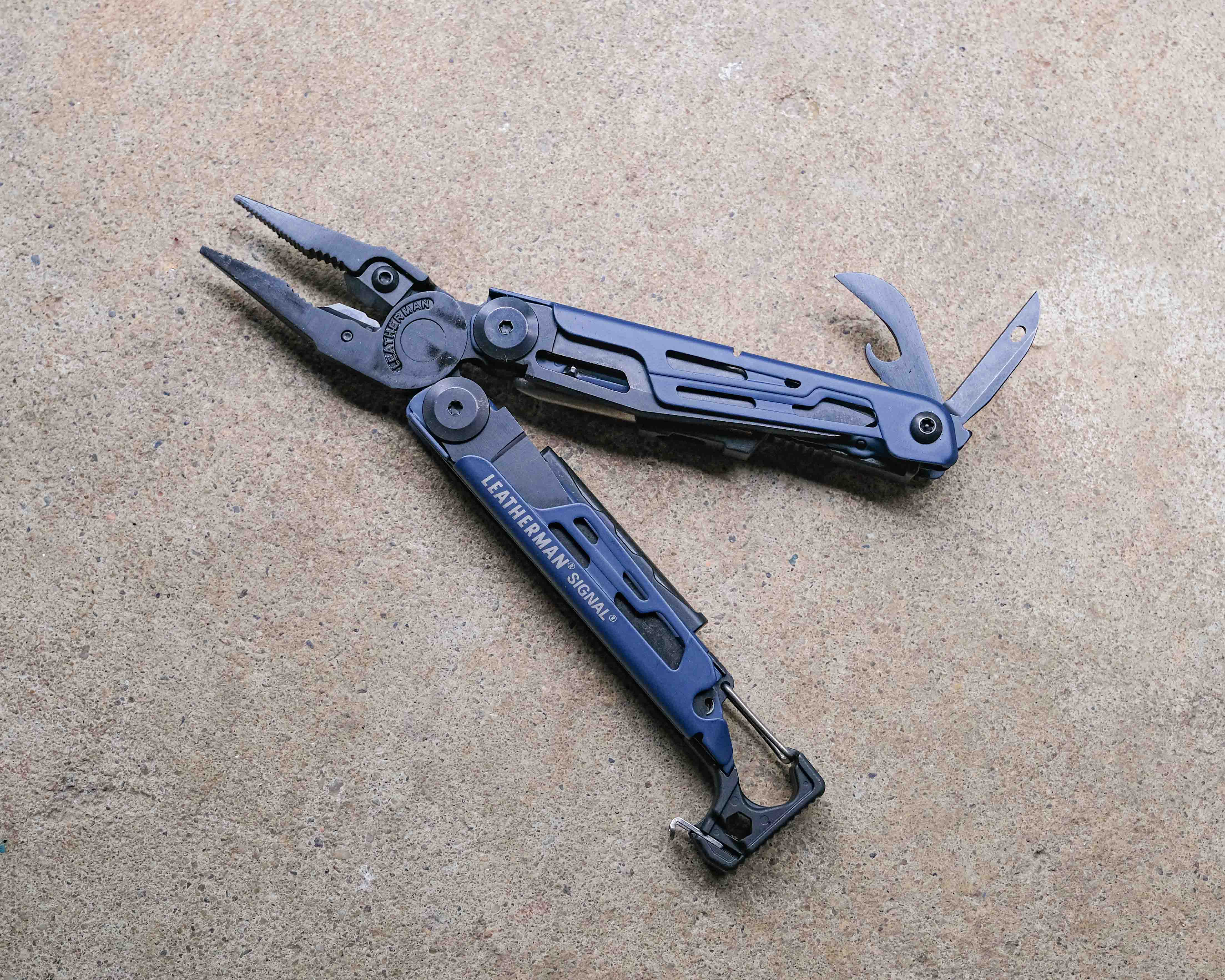 Leatherman multi-tool on concrete backdrop