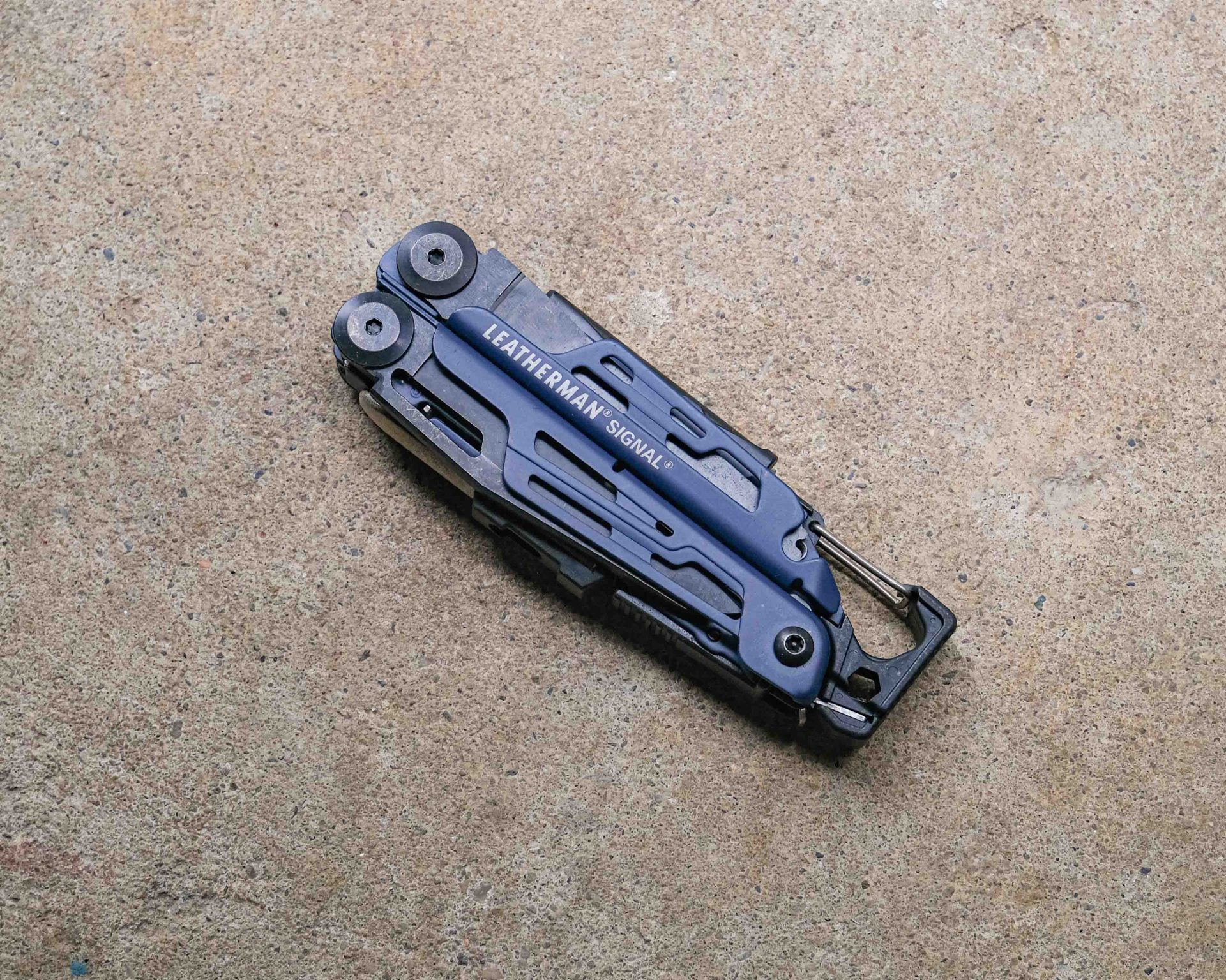 Leatherman multi-tool on concrete backdrop