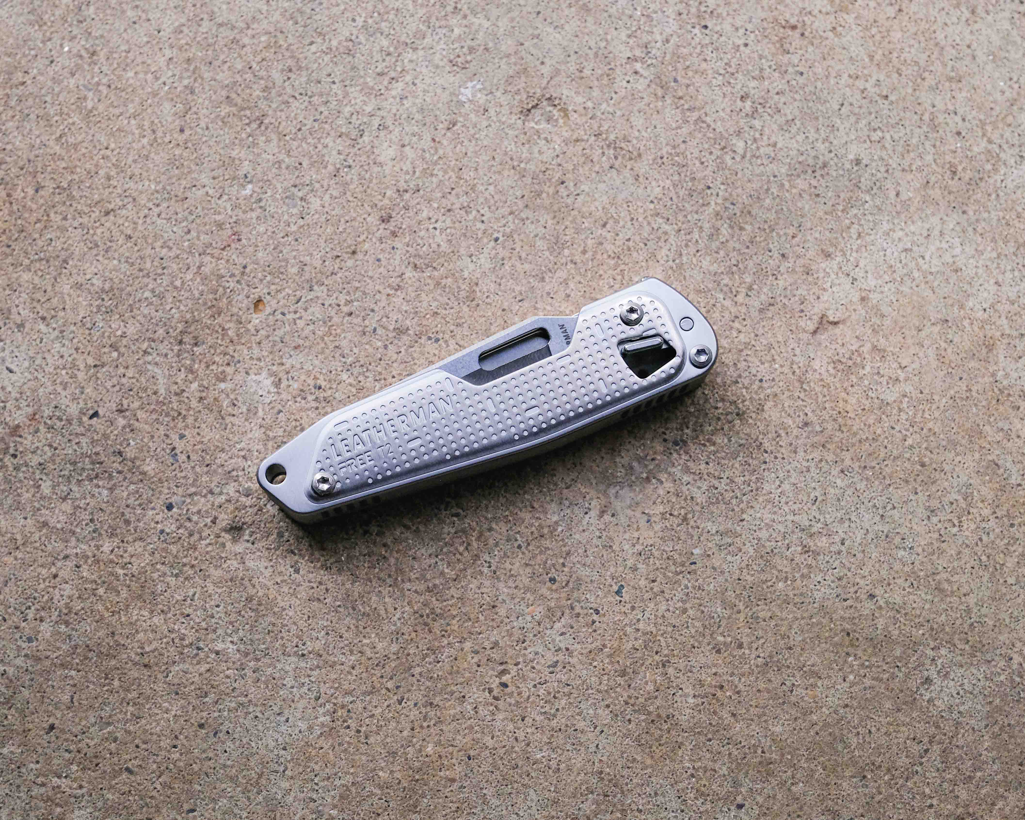 Leatherman multi-tool on concrete backdrop