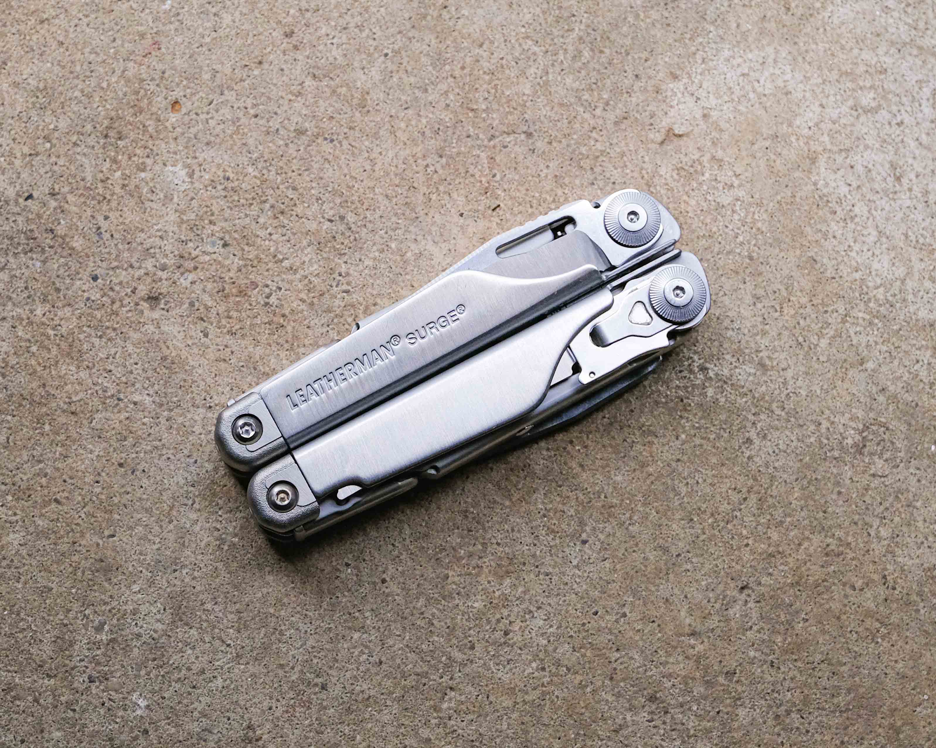 Leatherman multi-tool on concrete backdrop