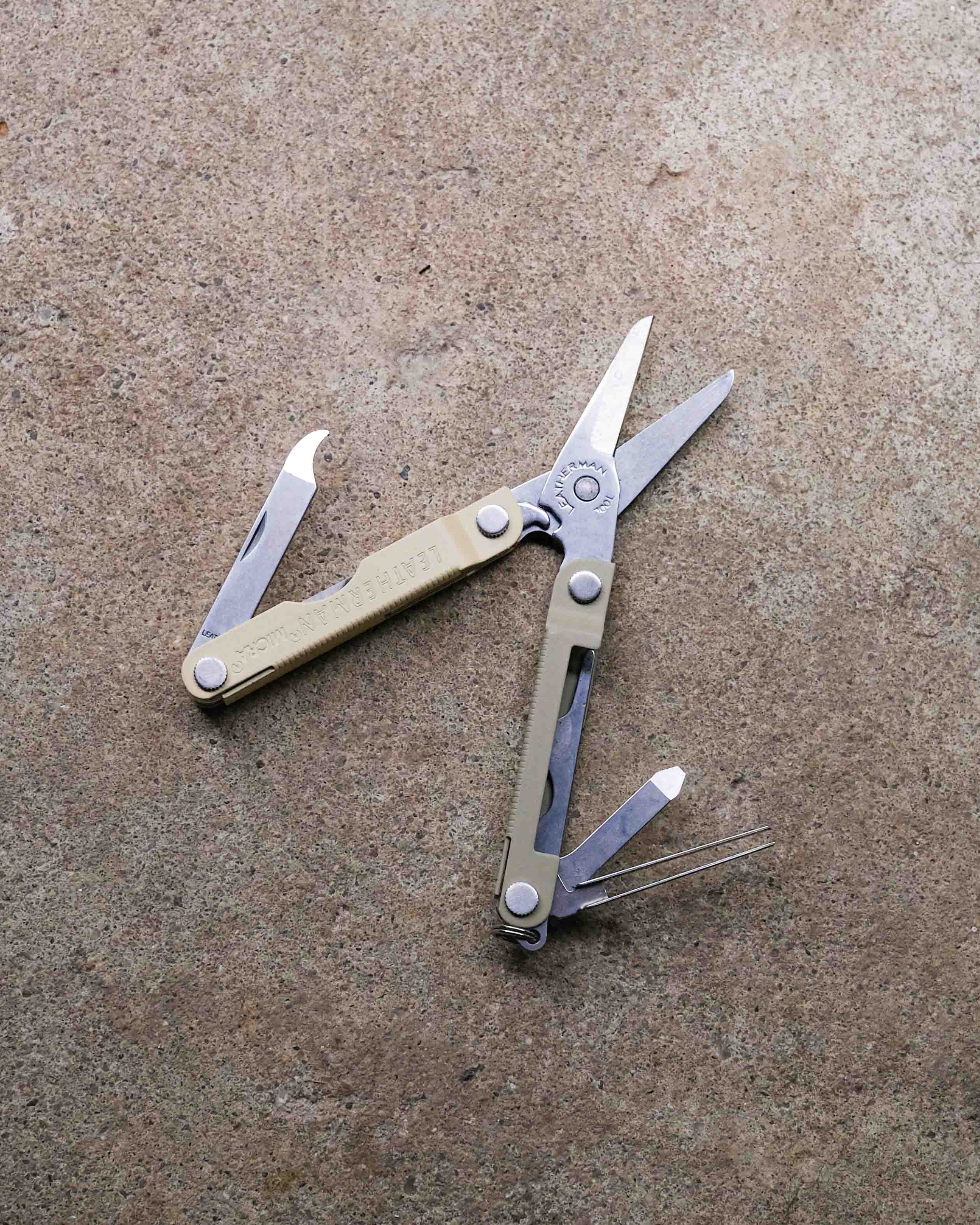 Leatherman multi-tool on concrete backdrop