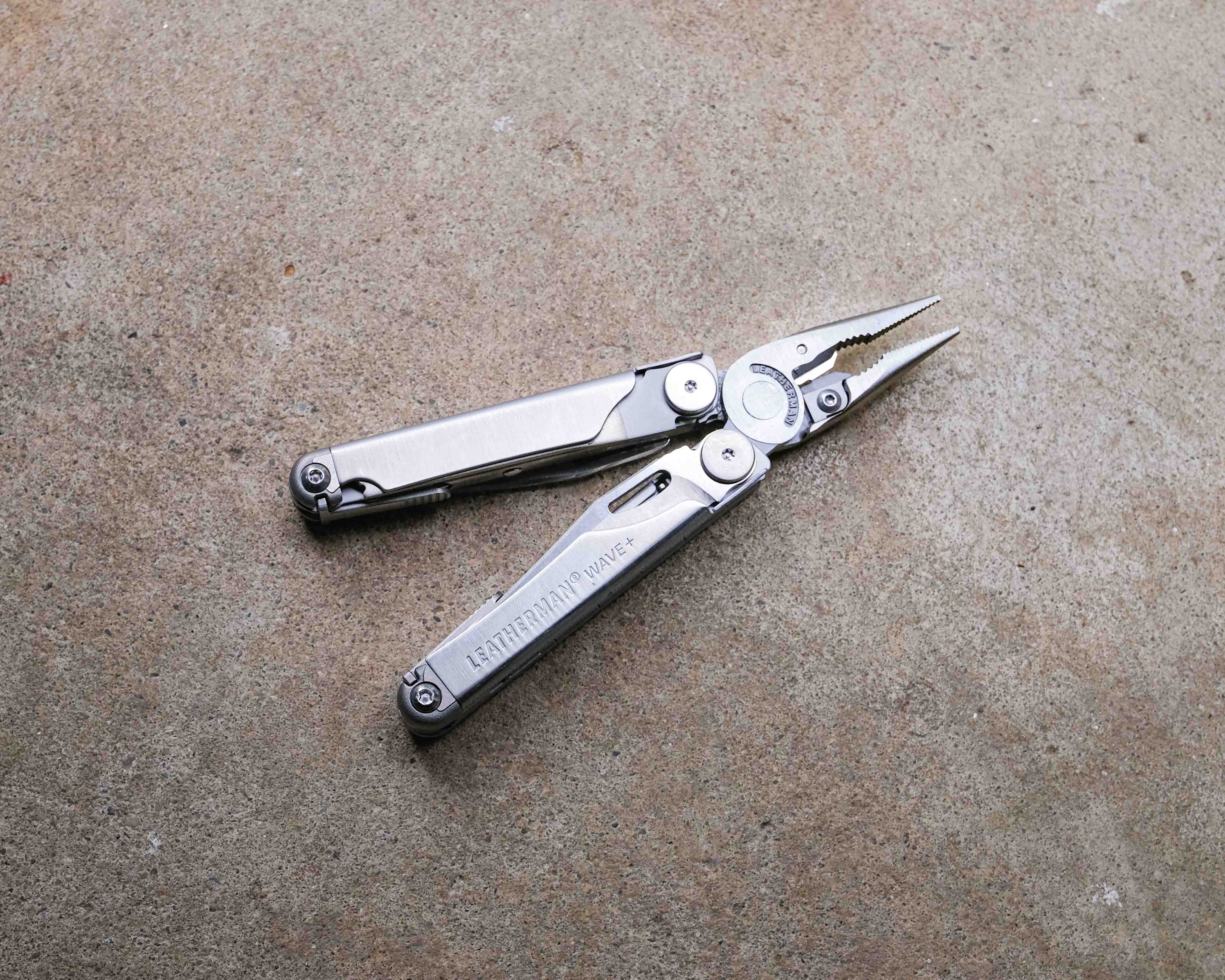 Leatherman multi-tool on concrete backdrop