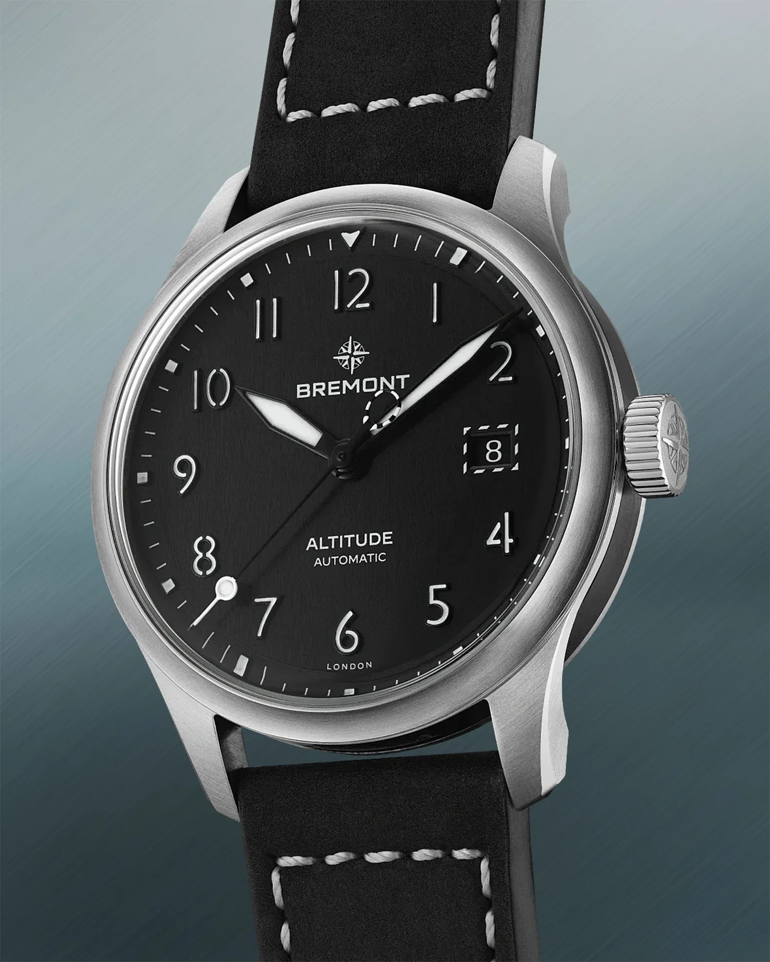 a black pilots watch with a black leather strap